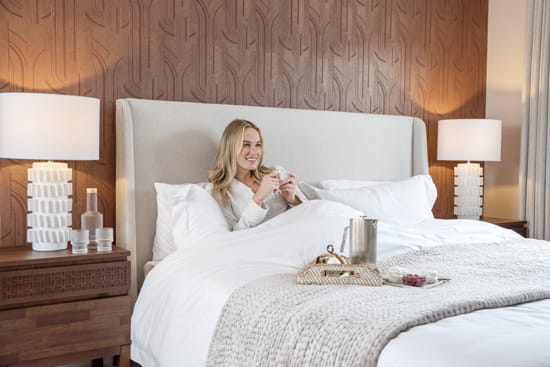 Lady in bed with cup of coffee